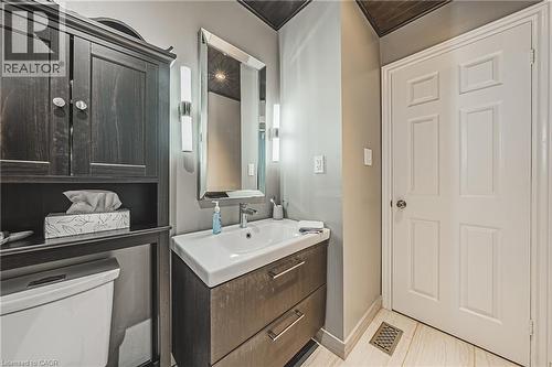 Wall-mounted vanity with integrated sink, rectangular mirror, and sconce lighting - 266 Limeridge Road E Unit# 3, Hamilton, ON 