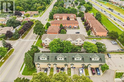 Multi-unit property with dormer windows and individual parking spaces, surrounded by mature trees - 266 Limeridge Road E Unit# 3, Hamilton, ON 