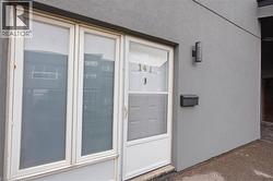 Exterior featuring a stucco facade, an outdoor sconce, and a wall-mounted mailbox - 