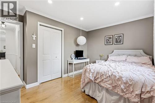 Recessed lighting illuminates this room, featuring wood-finish flooring, crown molding, and neutral wall tones - 72 Crestlynn Crescent, Simcoe, ON 