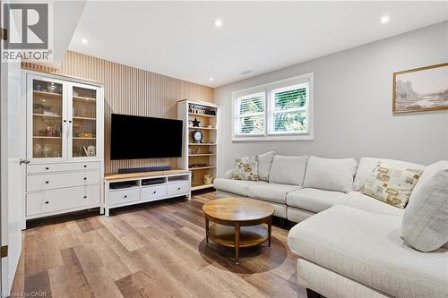Interior room featuring wood-finish flooring, recessed lighting, and a window with white blinds - 72 Crestlynn Crescent, Simcoe, ON 