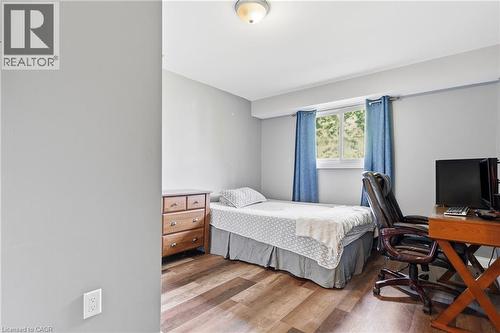 Room featuring wood-finish flooring, a window with natural light, and light grey painted walls - 72 Crestlynn Crescent, Simcoe, ON 