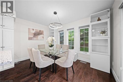 Dark wood-finish flooring with white baseboards - 495 Brigantine Drive, Waterloo, ON 