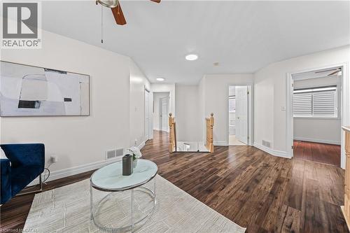 Recessed ceiling lighting, wood-finish flooring, white painted walls, and wood railings - 495 Brigantine Drive, Waterloo, ON 