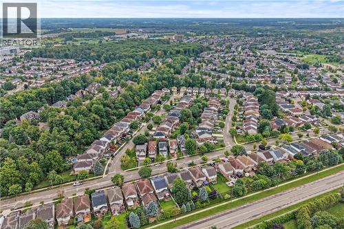 Aerial perspective of a developed residential area featuring numerous detached homes with varied architectural styles and surrounding green spaces - 495 Brigantine Drive, Waterloo, ON 