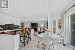 View of eating area, island seating & family room - 