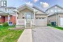 Brick and siding exterior featuring a covered front porch with white railing, an attached single-car garage, and a concrete driveway - 168 Copper Leaf Street, Kitchener, ON 