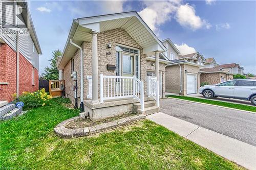 Brick exterior with white porch railings, concrete steps, and an asphalt driveway - 168 Copper Leaf Street, Kitchener, ON 