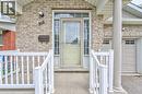 Brick exterior with a covered porch, white railing, and a side-light front entry door - 168 Copper Leaf Street, Kitchener, ON 