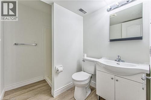 Wood-finish flooring with a toilet, vanity, and shower stall - 168 Copper Leaf Street, Kitchener, ON 
