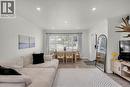 Open-concept living area featuring wood-finish flooring and recessed lighting - 450 Highland Road E, Kitchener, ON 