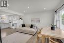 Open-concept living space featuring wood-finish flooring, recessed lighting, and white walls - 450 Highland Road E, Kitchener, ON 
