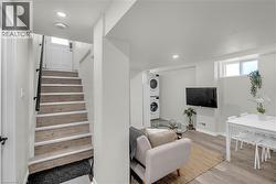 Hardwood-finish stairs with black handrail - 