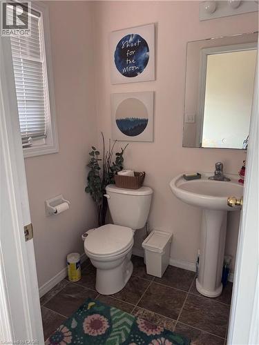Bathroom featuring a pedestal sink, wall-mounted mirror, and tile flooring - 452 Beaumont Crescent, Kitchener, ON 