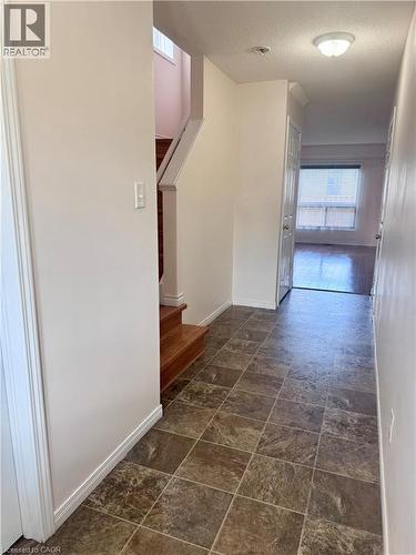 Foyer featuring square tile flooring and a neutral color palette - 452 Beaumont Crescent, Kitchener, ON 