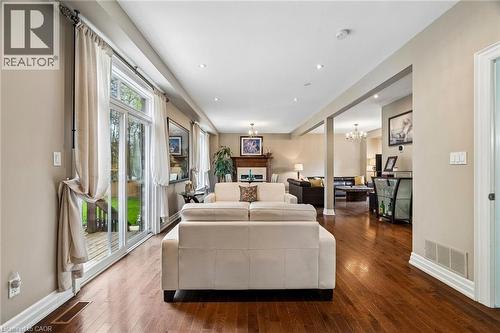 Expansive living area featuring rich wood-finish flooring, recessed lighting, and a neutral color palette - 1541 Garnet Avenue, Mississauga, ON 