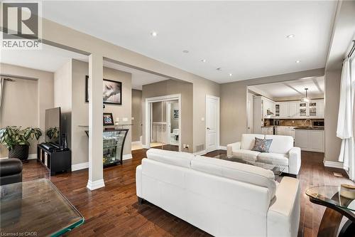 Open-concept living area featuring wood-finish flooring, recessed lighting, and neutral wall tones - 1541 Garnet Avenue, Mississauga, ON 