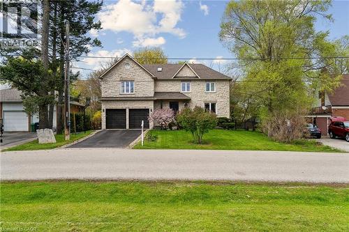Two-story residence featuring stone masonry and a prominent front-facing gable - 1541 Garnet Avenue, Mississauga, ON 