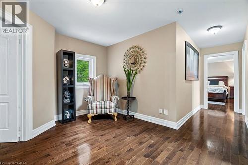 Hallway featuring dark wood-finish flooring, light neutral wall tones, and white baseboards - 1541 Garnet Avenue, Mississauga, ON 