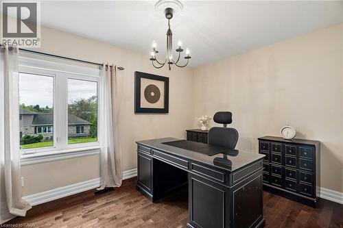 Bright room featuring wood-finish flooring, white baseboards, and a double window - 1541 Garnet Avenue, Mississauga, ON 