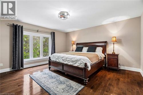 Spacious room featuring wood-finish flooring, a large multi-pane window, and neutral wall tones - 1541 Garnet Avenue, Mississauga, ON 