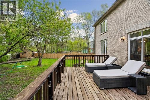 Expansive wooden deck with a dark wood railing, overlooking a lush green lawn - 1541 Garnet Avenue, Mississauga, ON 