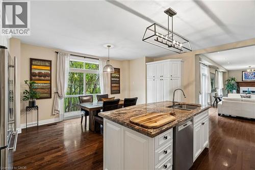 Kitchen island with an undermount sink, gooseneck faucet, and integrated dishwasher - 1541 Garnet Avenue, Mississauga, ON 