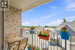 Balcony with brick exterior and black metal railing - 