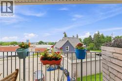 Balcony featuring a black metal railing and a wood-slat privacy screen - 