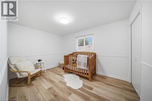 Bright room featuring vinyl flooring, white walls with wainscoting, and a ceiling-mounted light fixture - 2306 Devon Road, Oakville, ON 
