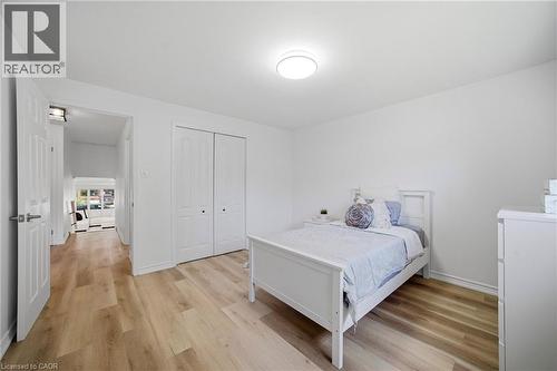 Bedroom featuring vinyl flooring, white walls, and a flush-mount ceiling light - 2306 Devon Road, Oakville, ON 