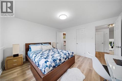 Light vinyl flooring complements crisp white walls - 2306 Devon Road, Oakville, ON 