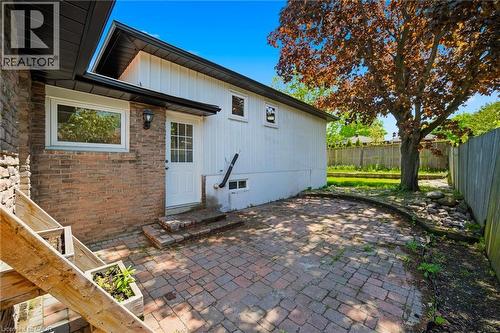 Exterior brick and vertical siding with white trim - 2306 Devon Road, Oakville, ON 
