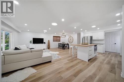 Open-concept living space featuring vinyl flooring, recessed lighting, and white walls - 2306 Devon Road, Oakville, ON 
