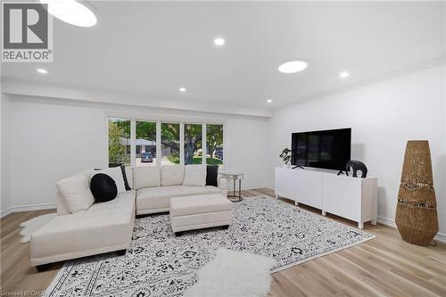 Spacious living area featuring vinyl flooring, recessed lighting, and a large bay window - 2306 Devon Road, Oakville, ON 