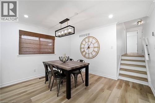 Dining area with vinyl flooring, white walls, and crown molding - 2306 Devon Road, Oakville, ON 