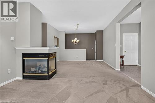 Open concept living / dining room with 3 way fireplace. - 159 Thoroughbred Boulevard, Ancaster, ON 