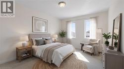Wall-to-wall carpeting, dual windows with natural light, and a ceiling-mounted light fixture - 