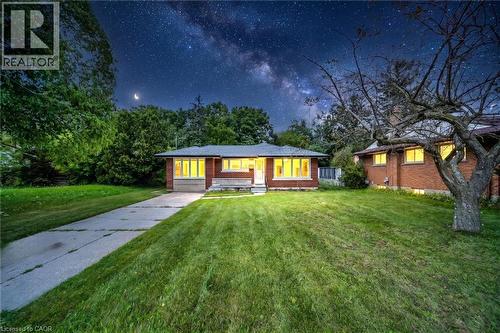 Brick exterior residence with a front lawn and paved driveway - 284 Cedar Crescent, Cambridge, ON 