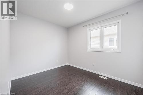 Recessed ceiling lighting, wood-finish flooring, white walls, white trim, and a white framed window - 224 Jessica Crescent Unit# B, Kitchener, ON 