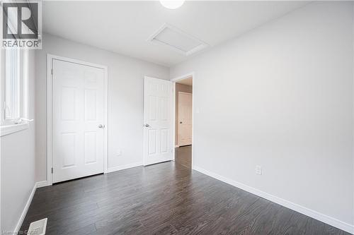 Wood-finish flooring, white walls, white doors, and a window with white trim - 224 Jessica Crescent Unit# B, Kitchener, ON 