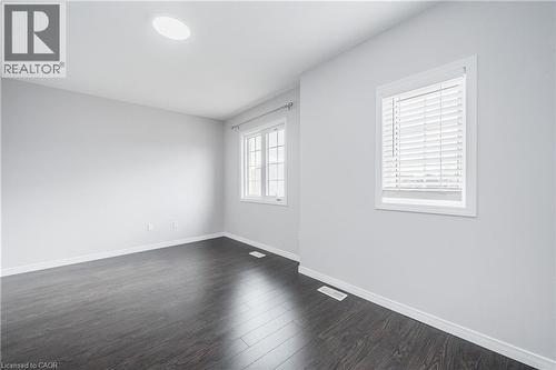Recessed ceiling light fixture, two windows with white blinds, and dark wood-finish flooring - 224 Jessica Crescent Unit# B, Kitchener, ON 