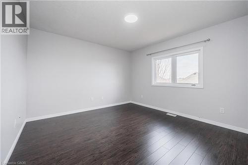 Recessed lighting, wood-finish flooring, white trim, and a window with a curtain rod - 224 Jessica Crescent Unit# B, Kitchener, ON 