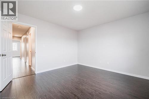 Recessed ceiling light fixture, dark wood-finish flooring, white trim, white interior door, light neutral wall color - 224 Jessica Crescent Unit# B, Kitchener, ON 