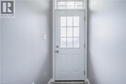 White paneled door with integrated glass panes and a transom window - 224 Jessica Crescent Unit# B, Kitchener, ON 