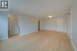 Light wood-finish flooring, white wall paint, and white trim - 