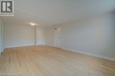 Light wood-finish flooring, recessed ceiling light fixture, white interior doors, and neutral wall paint - 141 Chapel Street, Kitchener, ON 