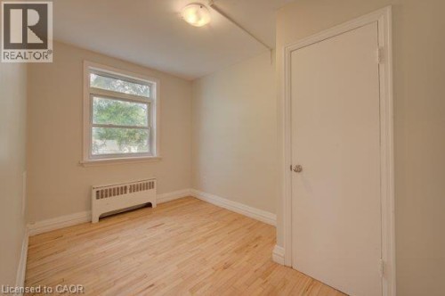 Hardwood flooring, painted walls, white trim, and a flush mount ceiling light - 141 Chapel Street, Kitchener, ON 