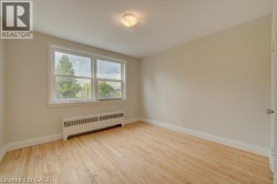 Light wood-finish flooring, white trim, and neutral wall tones - 