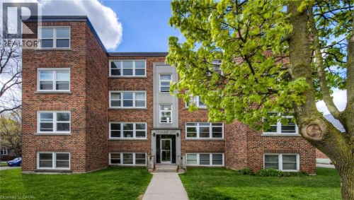 Brick exterior building with multiple windows - 141 Chapel Street, Kitchener, ON 
